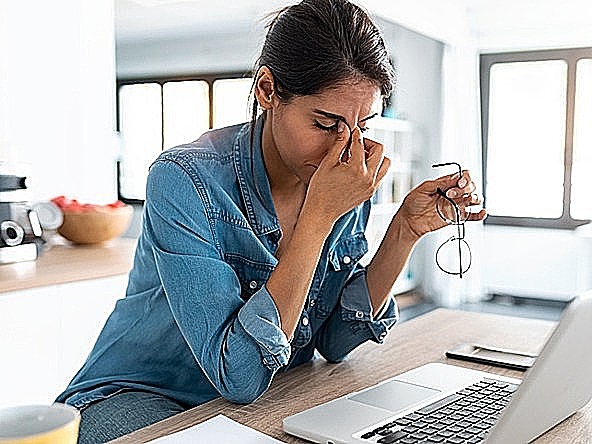 Woman at desk looking stressed